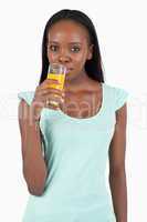 Young woman drinking some orange juice