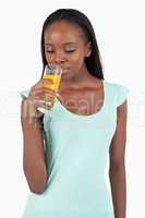 Young woman looking into her glass of orange juice