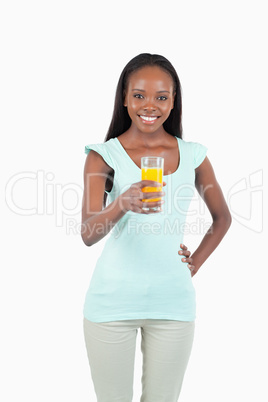Smiling young female having a glass of orange juice Smiling young female having a glass of orange juice