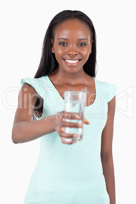 Happy smiling woman offering a glass of water