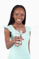 Refreshing glass of water offered by young woman