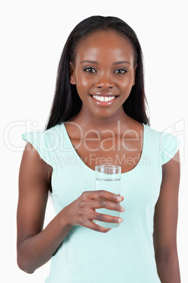 Happy smiling woman with a glass of refreshing water