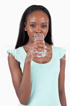 Young woman taking a sip of refreshing water