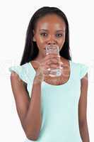 Young woman taking a sip of refreshing water