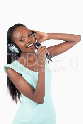 Happy smiling young woman singing