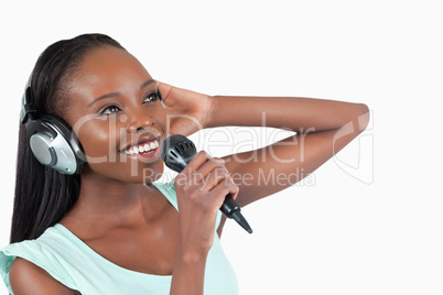 Smiling woman with headphones on singing