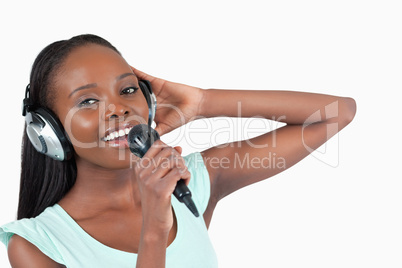 Woman with headphones on singing