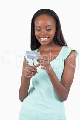 Happy smiling female destroying credit card