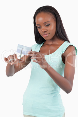 Woman cutting credit card into pieces
