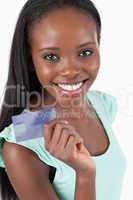 Smiling young woman with her new credit card
