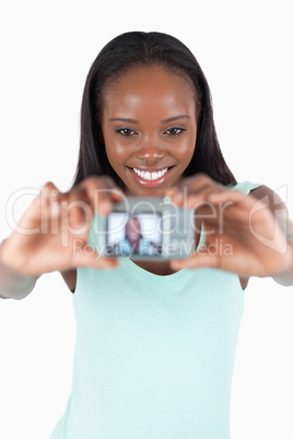 Smiling young woman taking photo of herself