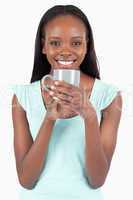 Smiling young woman with a cup of coffee