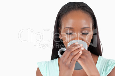 Young woman relaxing with a cup of coffee Young woman relaxing with a cup of coffee