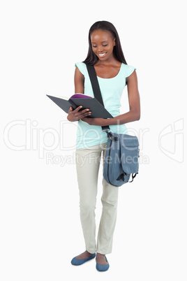Smiling student having a look at her book