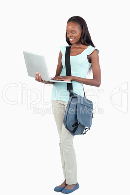 Side view of young student with her laptop