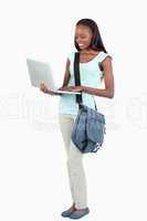 Side view of young student with her laptop