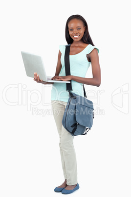 Side view of female student with her laptop