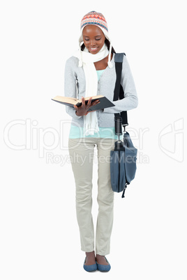 Smiling young student reading a book