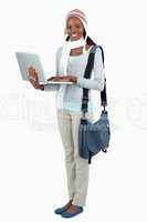 Side view of female student in winter clothing and laptop