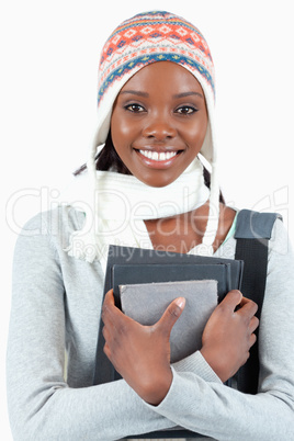 Close up of woman with winter clothes and books