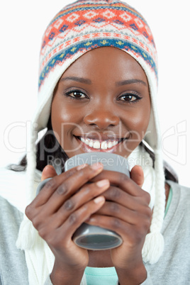 Smiling woman warming up with a cup of tea