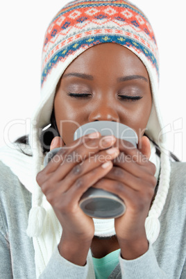 Young woman warming up with a cup of tea