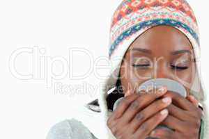 Young woman enjoying a cup of tea in the cold