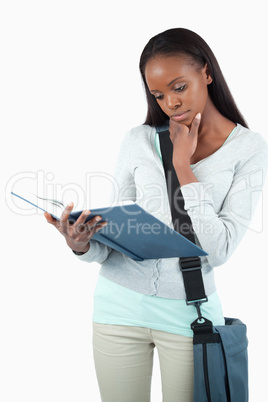 Young student with her book in thoughts