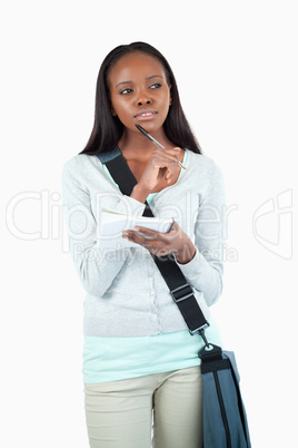 Young student in thoughts about her notes