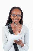 Smiling young woman with glasses and notepad