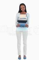 Young woman with a pile of books