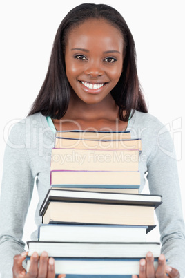 Happy smiling woman with pile of books