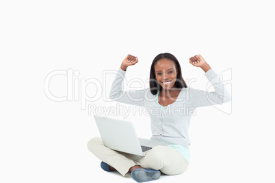 Young woman celebrating a successful online auction