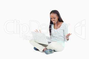 Young woman angry about her laptop on the floor