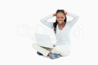 Young woman angry about her notebook sitting on the floor