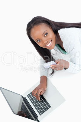 Smiling woman entering credit card information