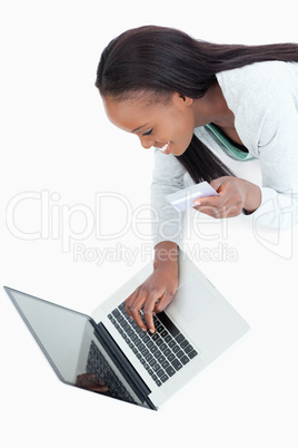 Smiling woman typing in her credit card information