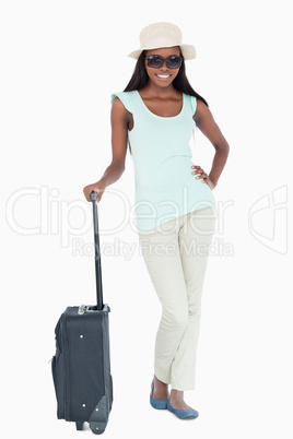 Smiling young woman with her suitcase