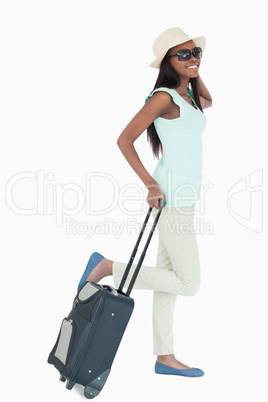 Happy young woman with her suitcase