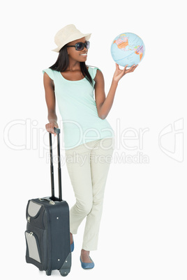 Smiling young woman traveling the world