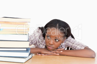 Student looking at a stack of books