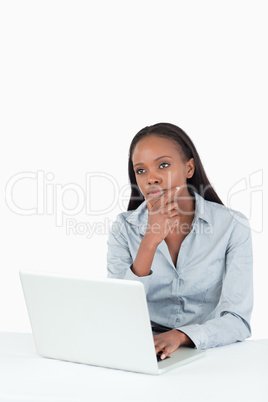 Thoughtful businesswoman using a laptop