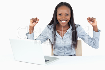 Cheerful businesswoman working with a laptop