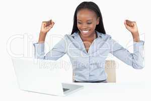 Joyful businesswoman working with a laptop
