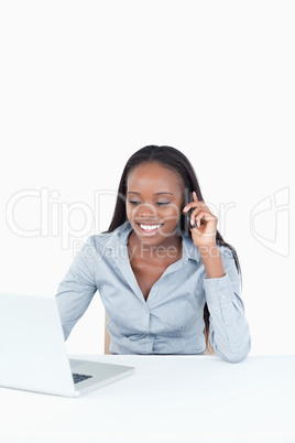 Portrait of a businesswoman making a phone call while using a la