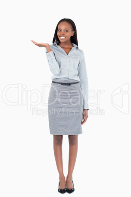 Portrait of a smiling businesswoman displaying something