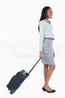 Portrait of a businesswoman walking with a suitcase