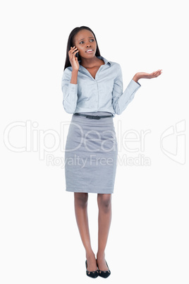 Portrait of a confused businesswoman making a phone call
