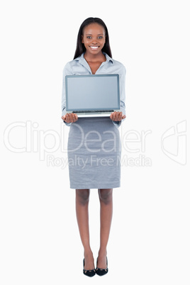 Portrait of a cute businesswoman showing a laptop