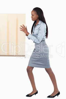 Portrait of a young businesswoman pushing a panel